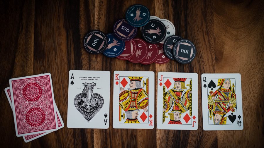 Poker rules how to play poker a pile of playing cards, credit to Unsplash Erik McCean